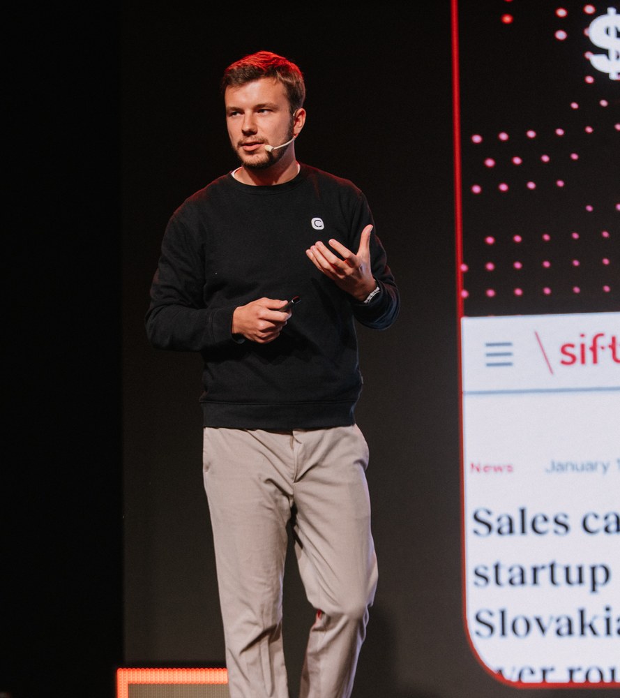 Milan Novotný speaking on stage at SEO Vibes Summit